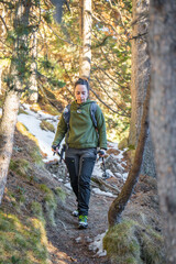 Hiker girl walking through forest of the Spanish Pyrenees