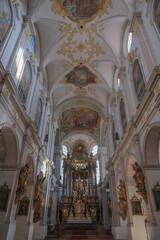 Magnificent opulent splendid Bavarian baroque church cathedral basilica interiors with stucco, murals, altar, Pilars, ceiling paintings, gold, wood domes nave