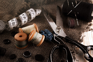Retro tools for cutting and sewing. Needle with thread, thimble, sewing machine and scissors