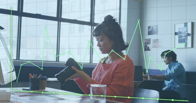 Animation of data processing over asian businesswoman working at office