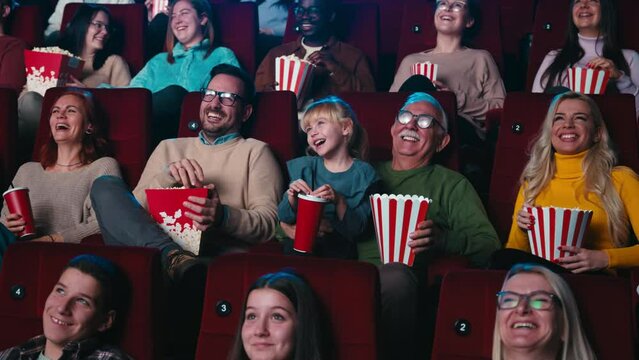 Cheerful audience laughing at movies.