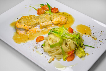 fish fillet of brook trout with almond crust au gratin stuffed with scallops on mango-tomato sauce and leek noodles