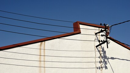 hanging electrical cables on industrial warehouse facade