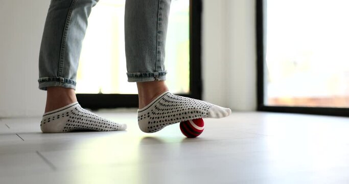 Person Rolls Massage Ball With Foot Closeup