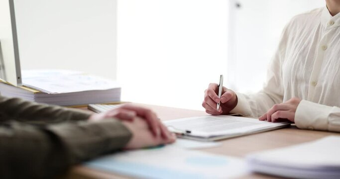Woman studies and signs contract or agreement after interview