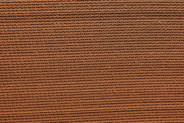 Fototapeta premium Corrugated cardboard. A stack of corrugated cardboard for packing. Background of Corrugated Brown Cardboard. Second life of paper, recycled material for packaging, Caring for the environment.
