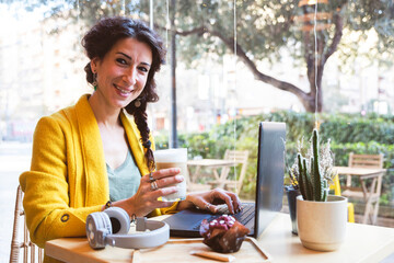 Businesswoman holds a smiling coffee shop in a coffee shop
