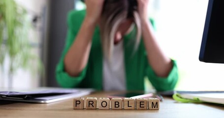 Stressed woman with problems holding head with hands in office
