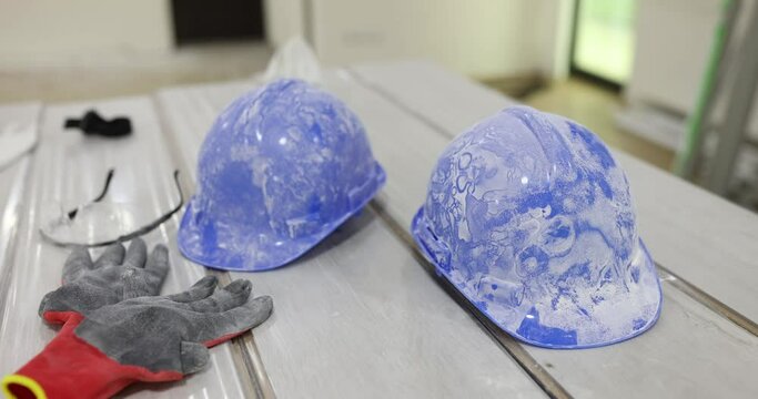 Blue construction helmets gloves and goggles closeup