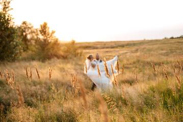 bride blonde girl and groom in a field