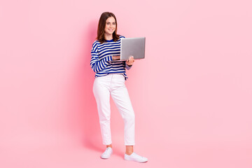 Full body portrait of charming positive lady hold use wireless netbook isolated on pink color background