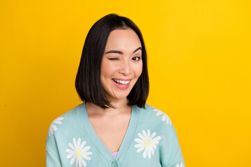 Photo of cheerful glad lady wear daisy flower print clothes winking eye good mood empty space...
