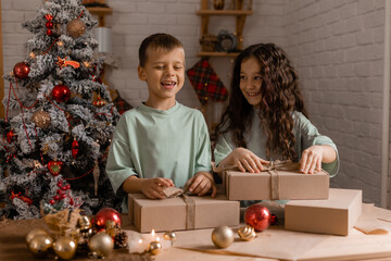 boy and a girl are sorting Christmas gifts packed in craft paper