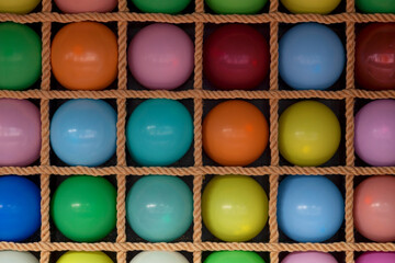 Row of balloons of a traveling carnival dartboard booth