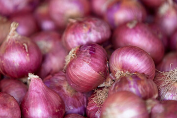 Stack of red onions on a market stall
