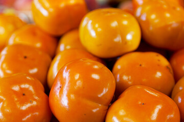 Stack of persimmons on a market stall