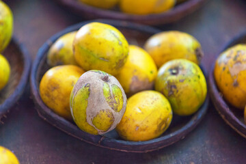 Bowl of ambarellas on a market stall