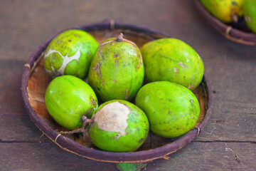Bowl of ambarellas on a market stall