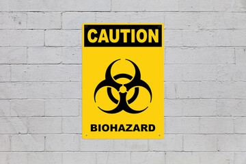 Caution, Biohazard sign on a cinder block wall