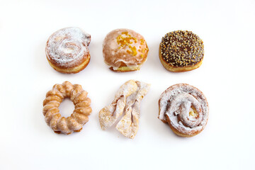 Different types of donuts on a white background. Sweet pastries for Fat Thursday