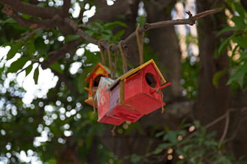 Red birdhouses in a tree