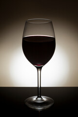Backlit glass of red wine