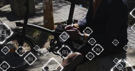 Animation of 6g text over caucasian businessman using smartphone - Powered by Adobe