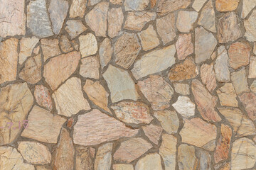 Beautiful texture of an old wall from orange stones with cracks