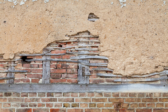 Half-timbered brick wall covered with daub