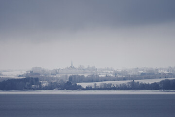 Fototapeta na wymiar Winter by Lake Mjøsa and Stange, with Stange church.