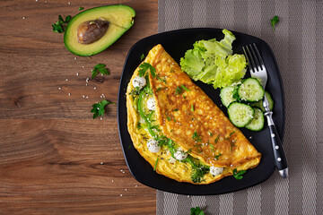 Omelette with mozzarella cheese and avocado. Ketogenic, keto diet breakfast. Top view, copy space
