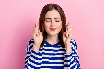 Photo of pretty lady closed eyes two arms crossed fingers beg hope isolated on pink color background