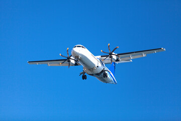 Propeller airplane landing to the airport