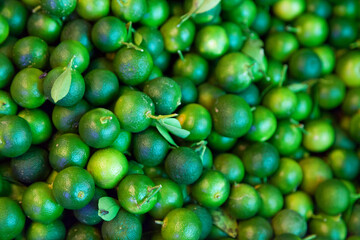 Stack of small limes on a market stall