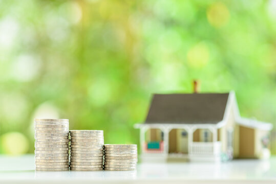 Home for sale, reverse mortgage, rent to own agreement, financial concept : One-story model house on a wood floor, depicting a buyer purchases a residential asset to live and invest for personal gain.