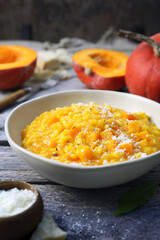 Italian food. Plate of pumpkin risotto and grated parmesan cheese