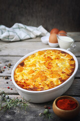 French cuisine. Vegetable pumpkin clafoutis in ceramic bakeware, eggs and cream