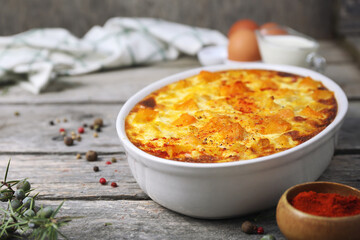 French cuisine. Vegetable pumpkin clafoutis in ceramic bakeware, smoked paprika dressing, eggs and cream - Powered by Adobe