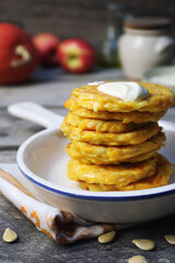 Stack of apple pumpkin pancakes with sour cream