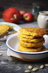 Stack of apple pumpkin pancakes with sour cream