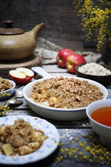 Fresh apple crumble from oatmeal, walnut dressing and cup of tea for healthy breakfast