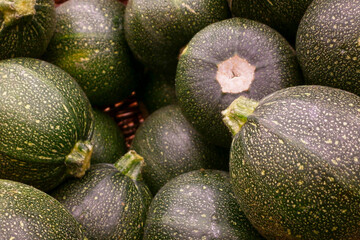 Stack of round zucchinis in a basket
