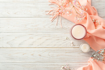 Hello spring concept. Top view photo of candles in glass holders pink soft plaid and gypsophila flowers on grey wooden table background with copyspace