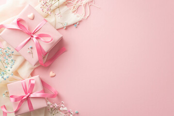 Spring concept. Top view photo of pink gift boxes with ribbon bows white scarf small hearts and gypsophila flowers on isolated pastel pink background with copyspace