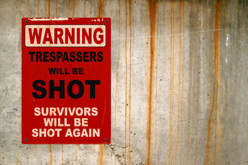 Naklejka premium Warning - Trespassers will be shot, survivors will be shot again