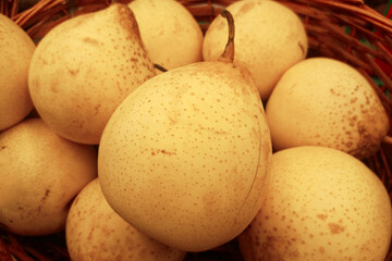 Stack of Nashi pears in a basket