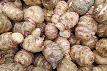 Stack of Jerusalem artichokes on a market stall