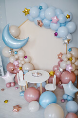 Children's photo zone with a lot of balloons. Decorations for boys and Girls Birthday party. Concept of children's birthday party. Cream-colored and pink balls.
