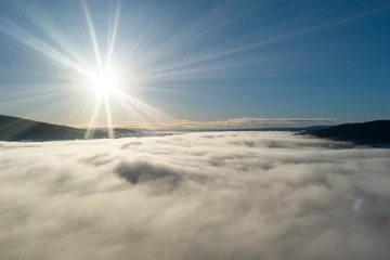 Fotobehang Drone shot of setting sun and cloud cover - high altitude aerial scene © Elmer Laahne PHOTO