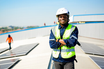 Smiling portrait of professional engineer technician working at solar cell farm power plant,...